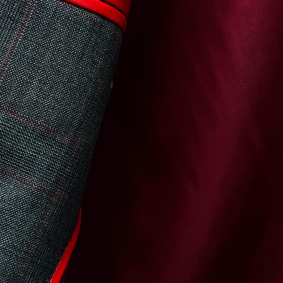 Pocket square detail on a men's grey windowpane suit, adding a touch of classic sophistication.