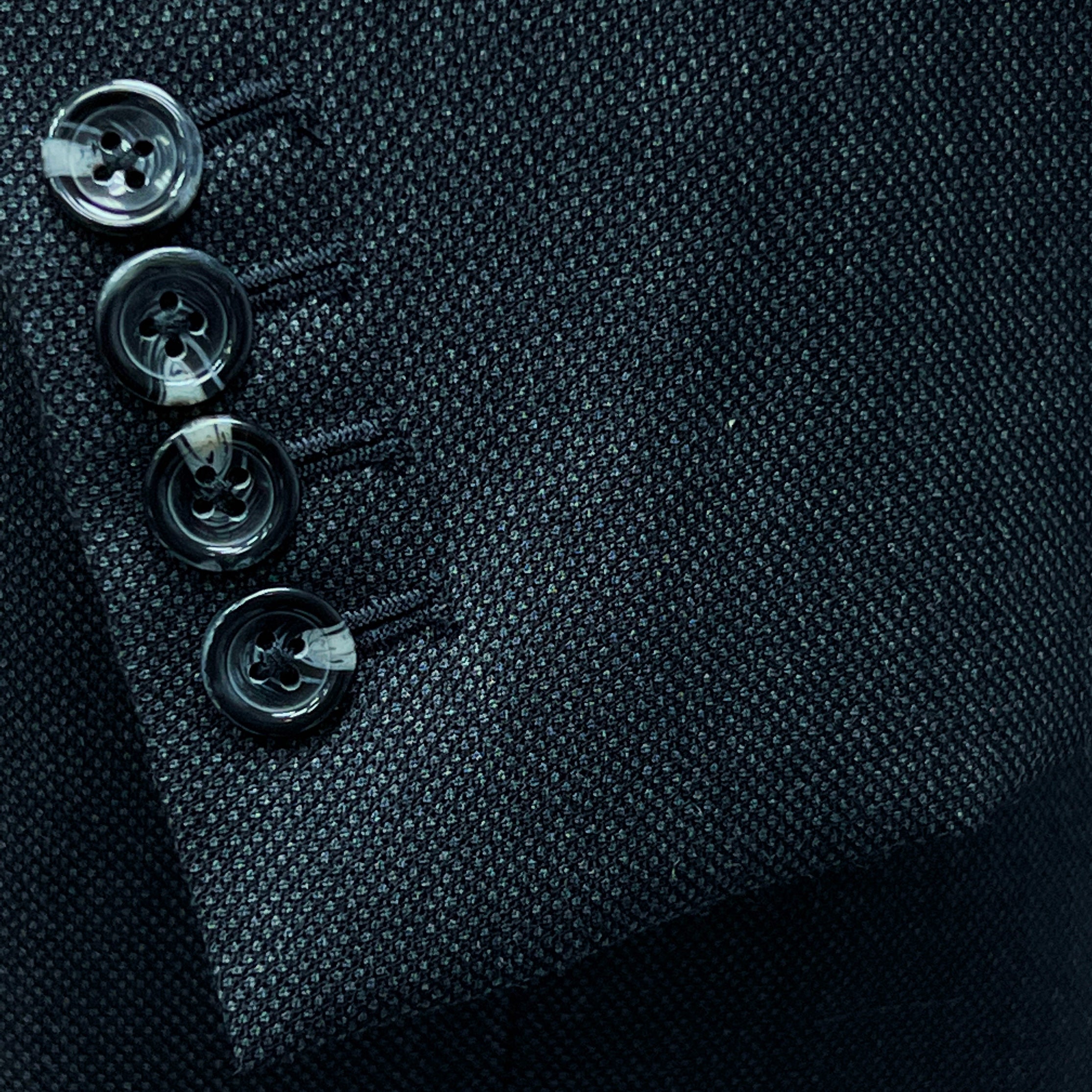Dark grey birdseye custom suit, close-up of the sleeve cuffs and buttons for work attire