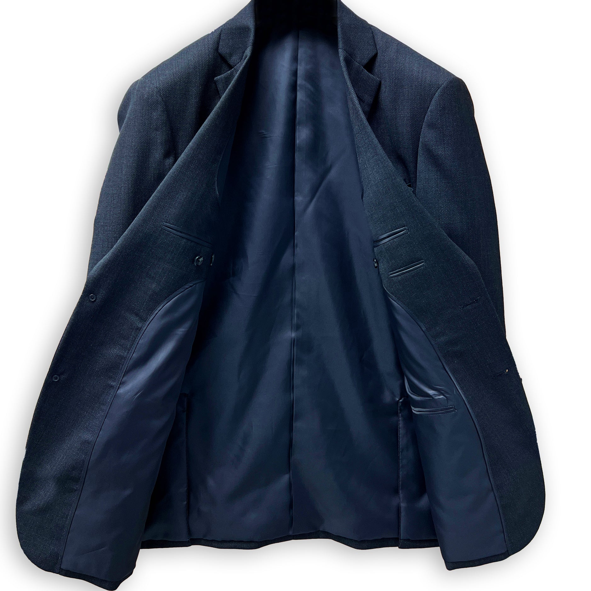 Men's custom tailored birdseye suit, side view highlighting the precise fit for work