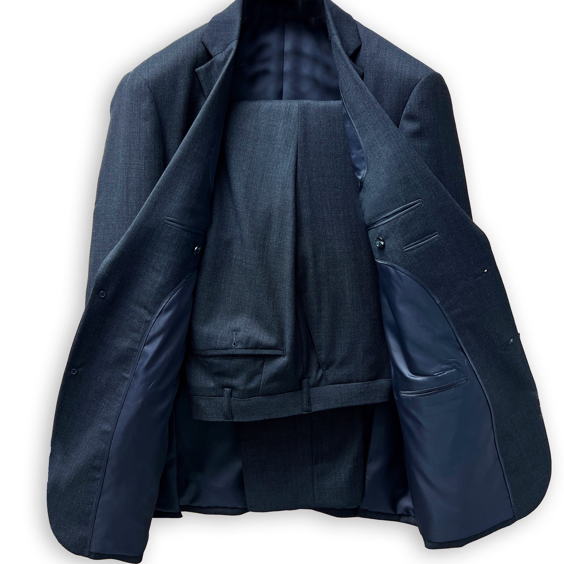 Men's custom tailored birdseye suit, side view highlighting the precise fit for work