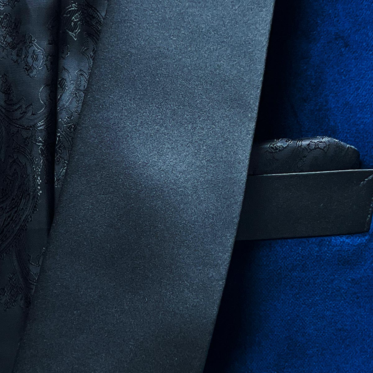 Lapel detail on a blue velvet tuxedo dinner jacket, a polished attire choice for formal dining and elegant evenings.