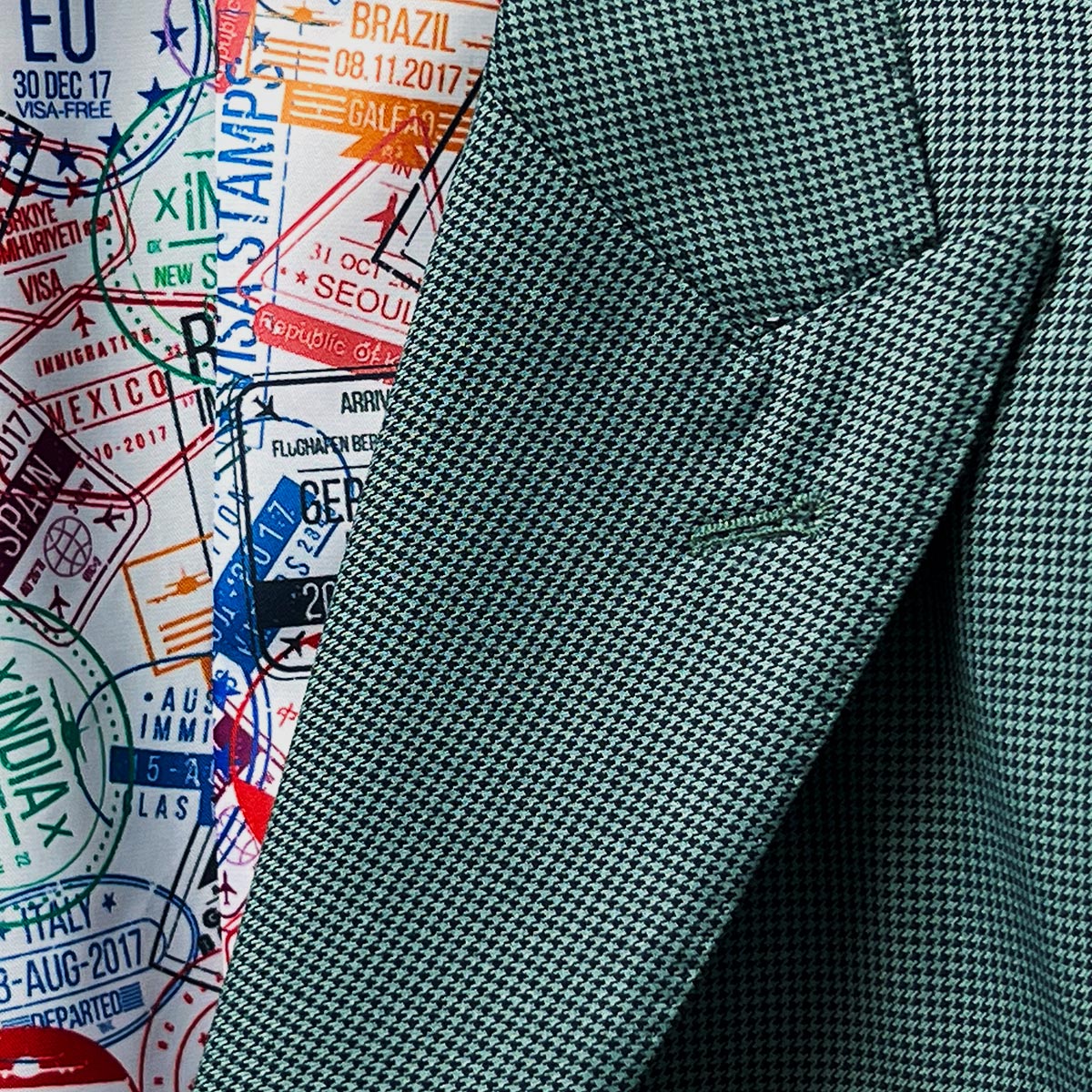 Lapel buttonhole detail on a hunter green houndstooth sportcoat.