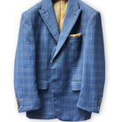 Detailed view of the tan windowpane plaid pattern on a stone blue suit.