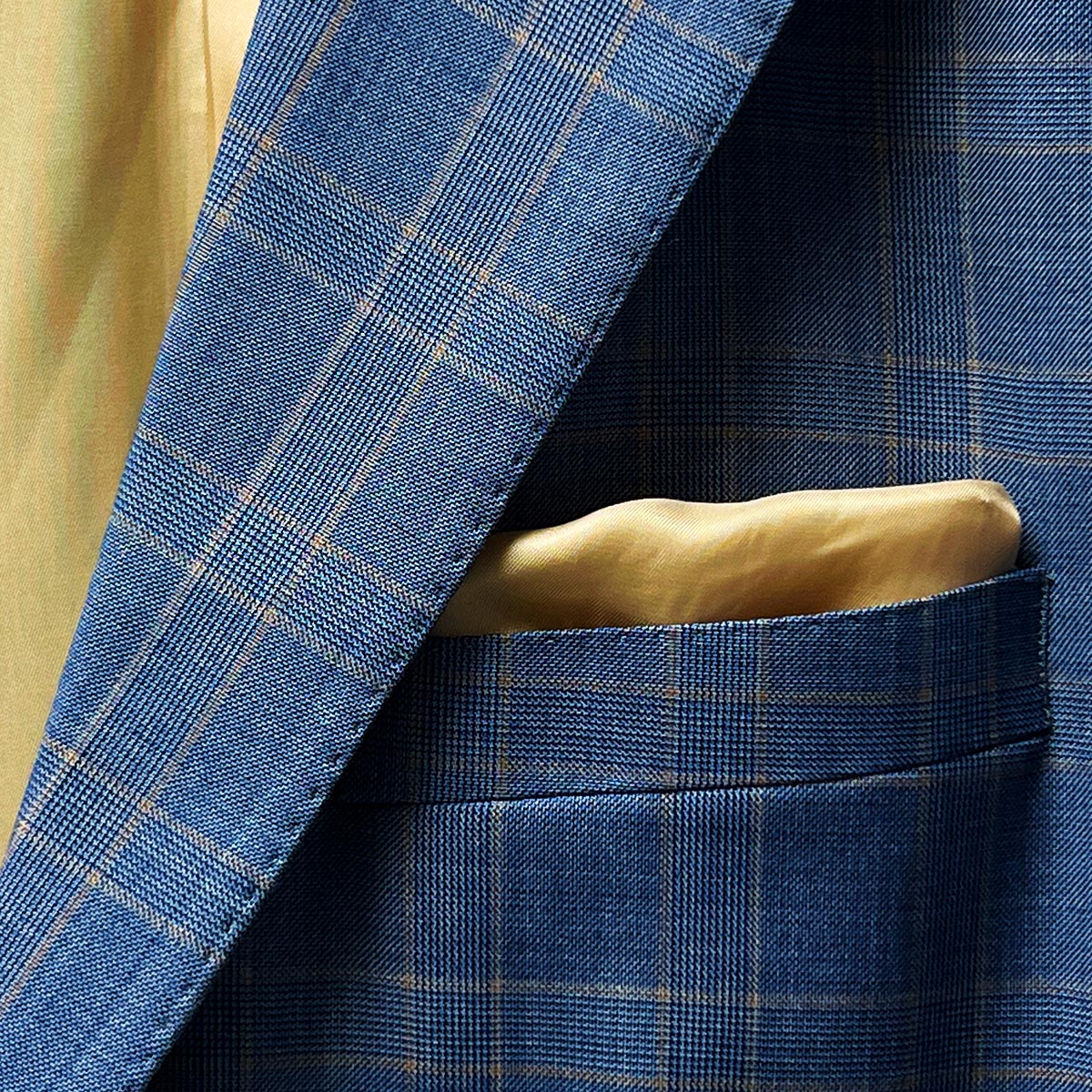 Pocket square adding a stylish element to a stone blue business suit.