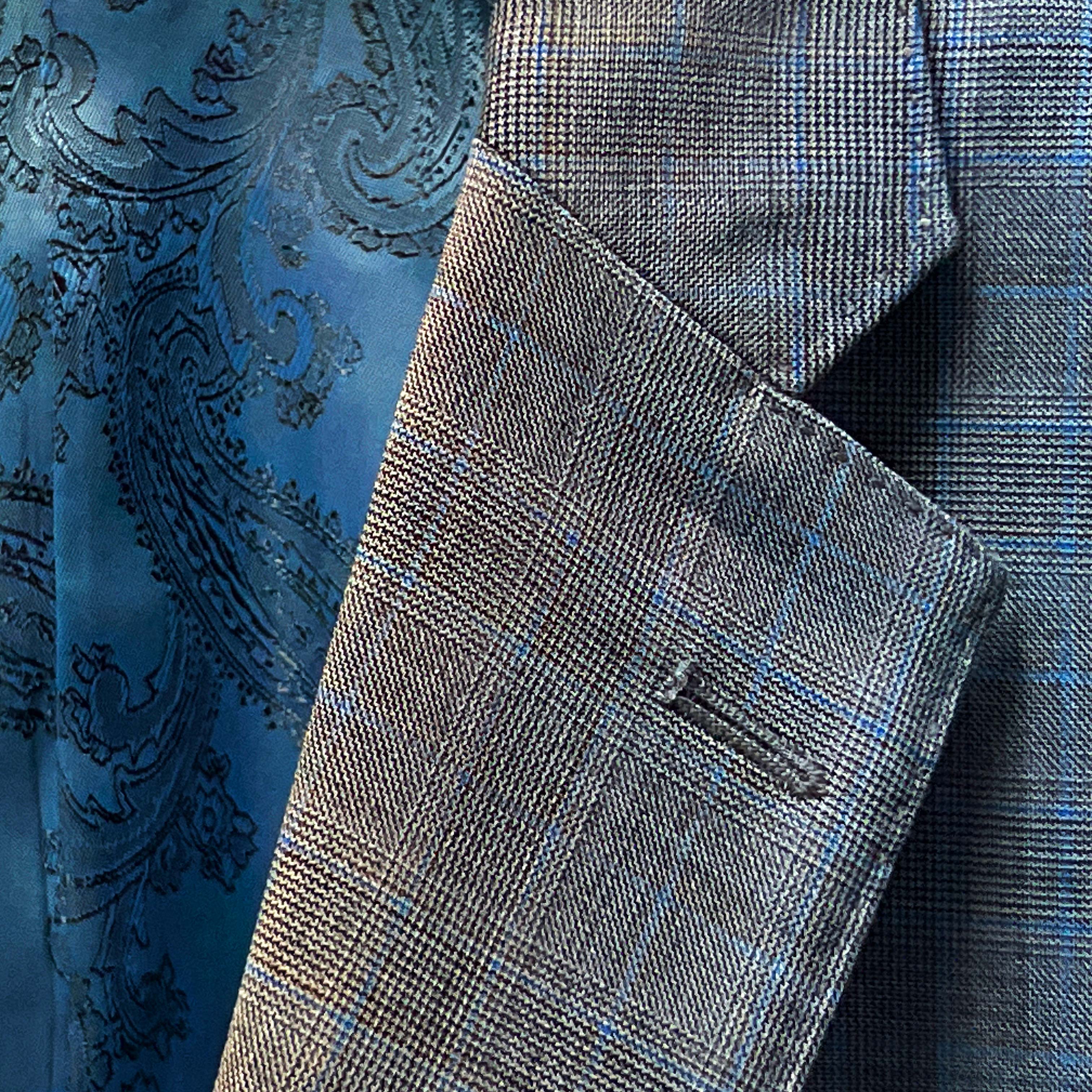 Suit button detail, blending with the black suit jacket theme.