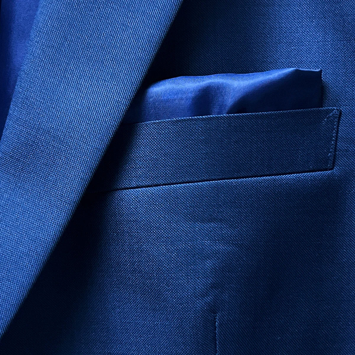 Image showcasing the built-in pocket square feature on the cobalt blue sharkskin suit.