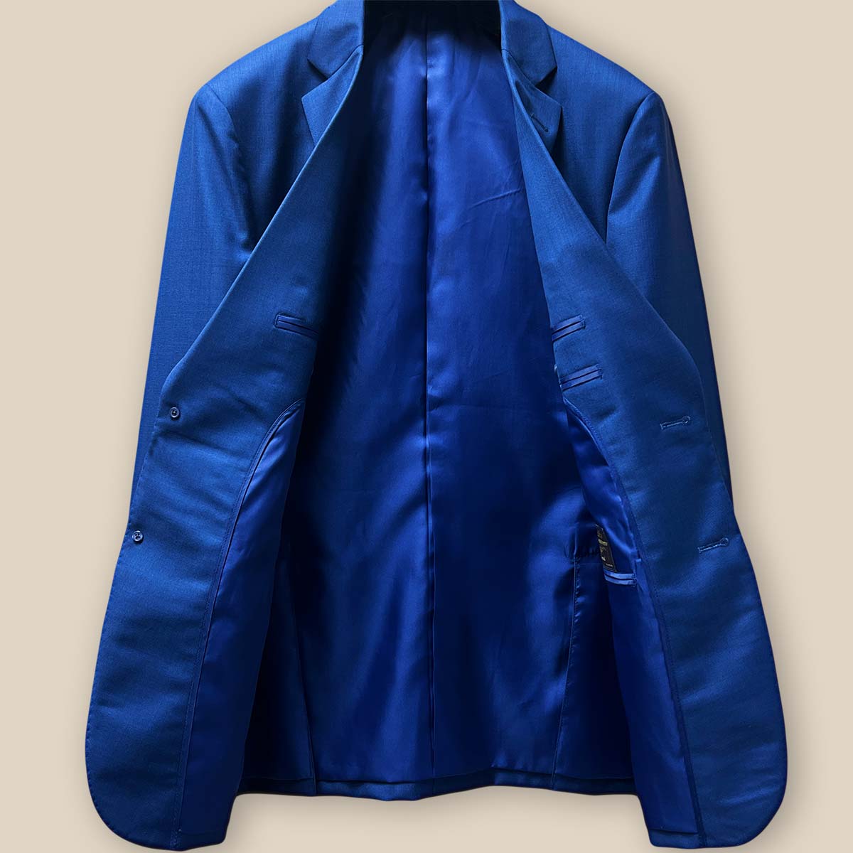 Full view of the inside lining of the cobalt blue sharkskin jacket, highlighting the royal blue silk bemberg lining.