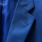Detailed view of the notch lapel on the cobalt blue sharkskin jacket, exemplifying classic tailoring.