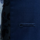 Macro shot of white contrast buttonhole stitching on royal navy blue sharkskin fabric