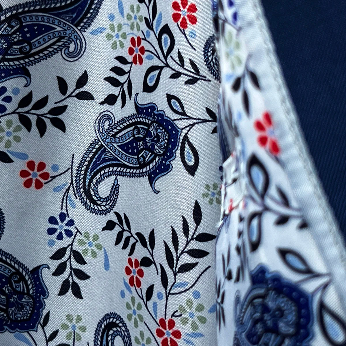 Interior jacket view highlighting the vibrant white, blue, and red floral and paisley flash linings