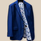 Interior view of custom suit jacket's left side, revealing white lining with blue and red floral and paisley pattern