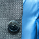 Close-up of the grey marble horn buttons on the light grey sharkskin suit.