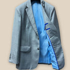 Inside left view of the light grey suit jacket showing the sky blue bemberg silk lining and royal blue contrast piping.