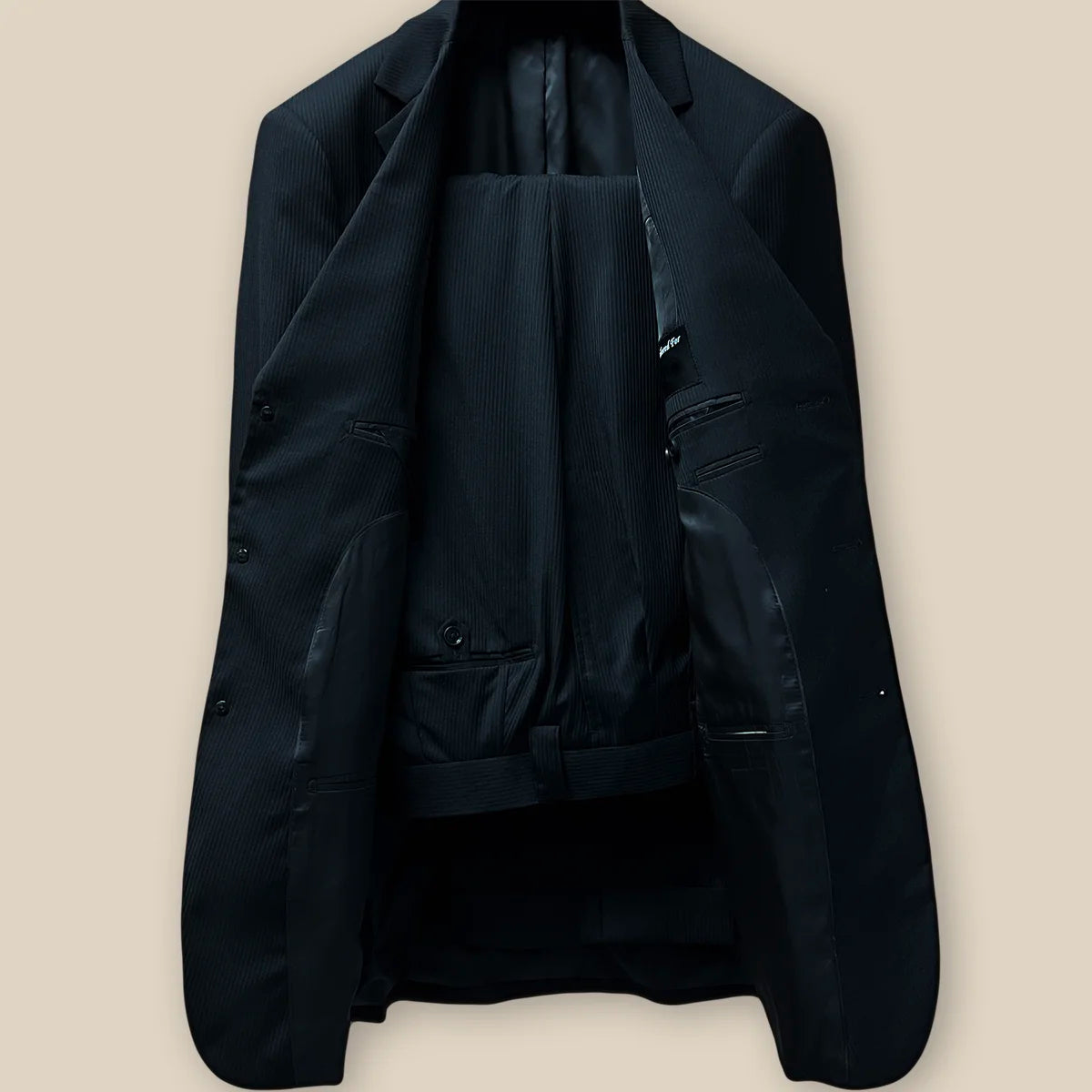 Full view of the two-piece suit, displaying the elegant black herringbone pattern and tailored fit.