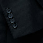Close-up of the functional sleeve buttonholes, featuring the black horn buttons and careful tailoring.