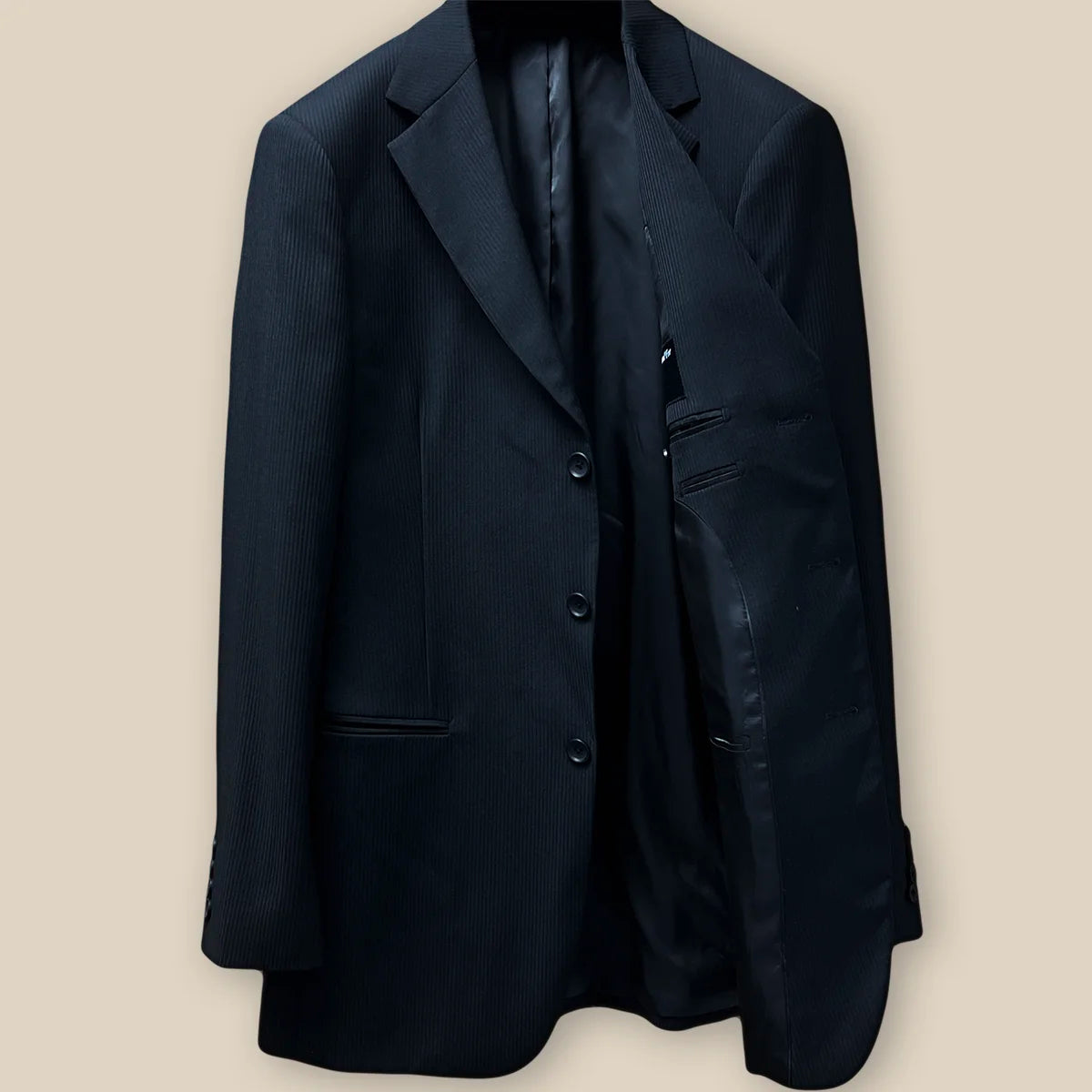 Inside view of the left side of the jacket, featuring the smooth black Bemberg lining and inner pocket.