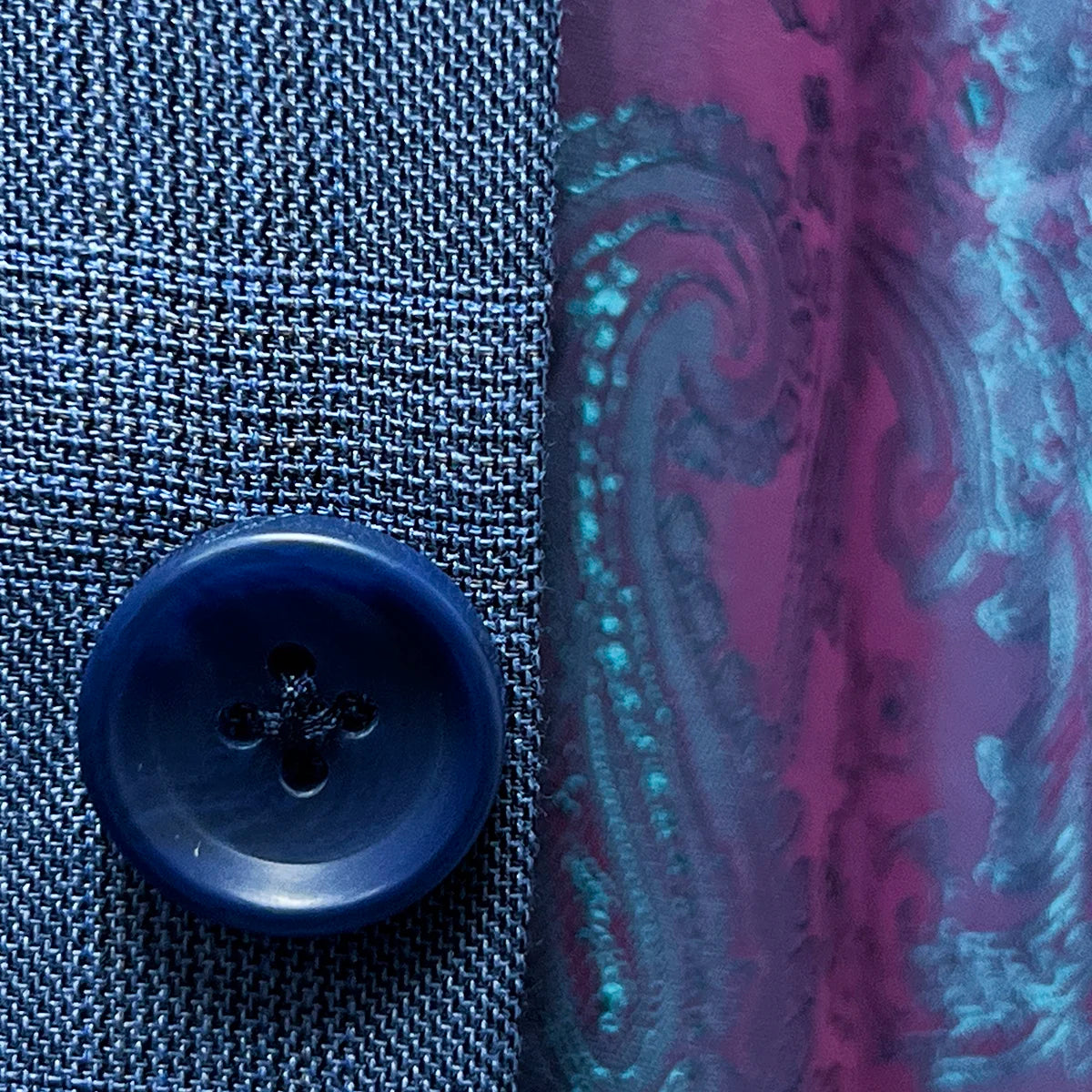 Detailed view of the medium blue horn marble buttons on the suit jacket, emphasizing their quality and style.