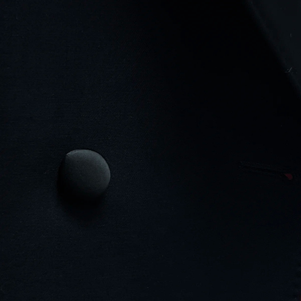 Close-up of the satin buttons, adding a unique touch to the tuxedo’s design.