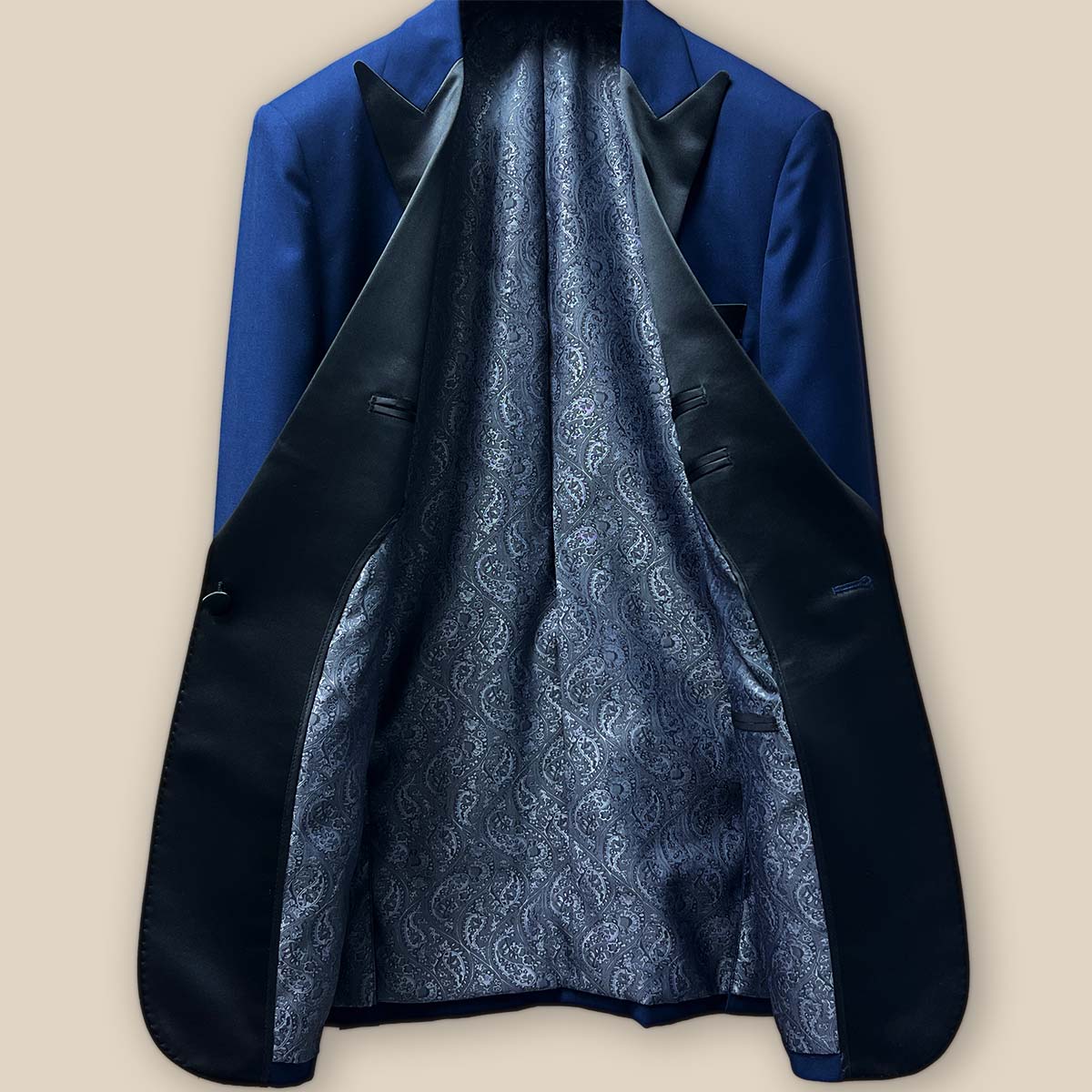 Interior view of the tuxedo jacket, highlighting the luxurious silver paisley flash lining and craftsmanship.
