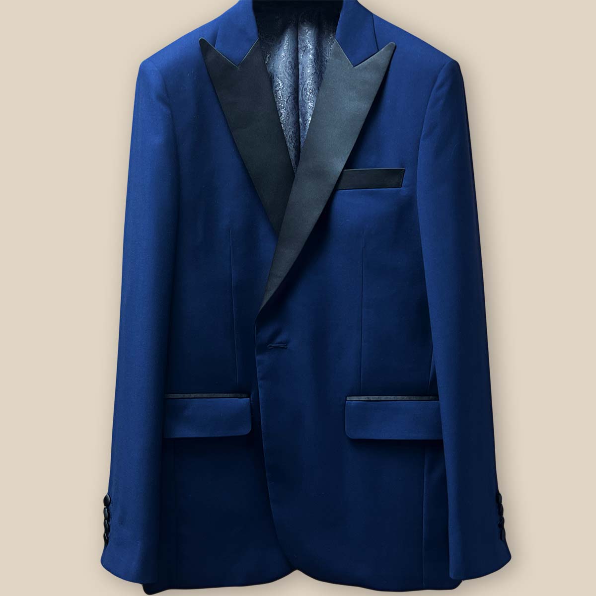 Close-up view of the tuxedo jacket buttonhole panel, showcasing the navy blue plain fabric and meticulous stitching.