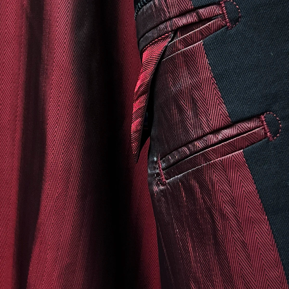 Detailed image of the maroon silk bemberg lining illustrating its smooth and luxurious texture.