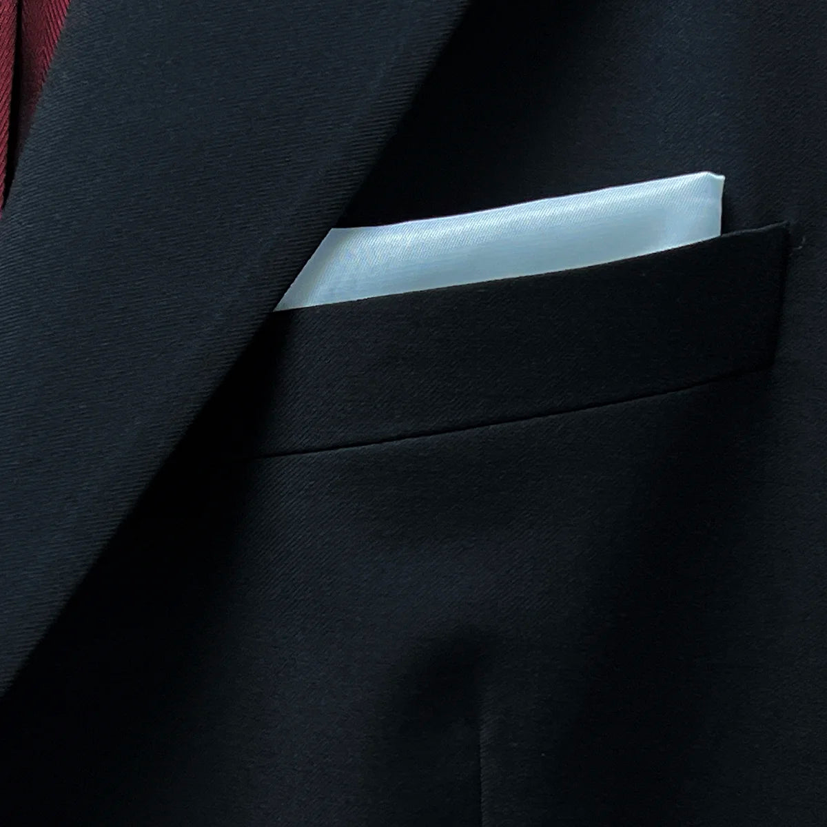 Close-up of the white bemberg lining pocket square integrated into the jacket design.
