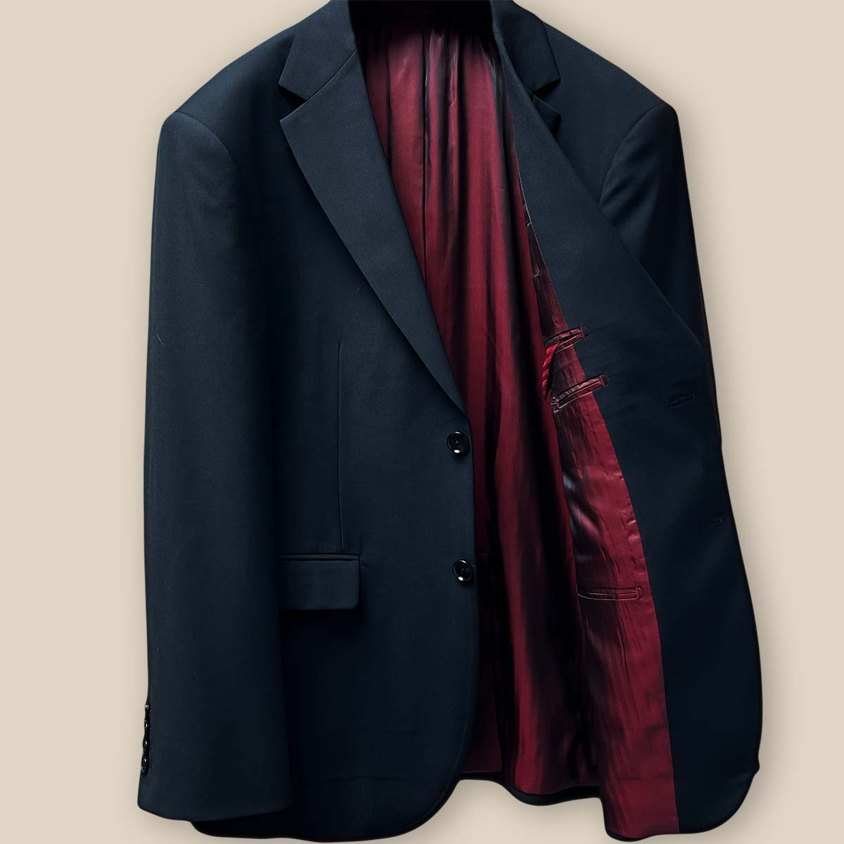 Inside view of the left side of the jacket highlighting the maroon silk bemberg lining and the white bemberg lining pocket square.
