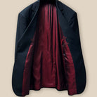 Interior view of the jacket displaying the maroon silk bemberg lining in full detail.