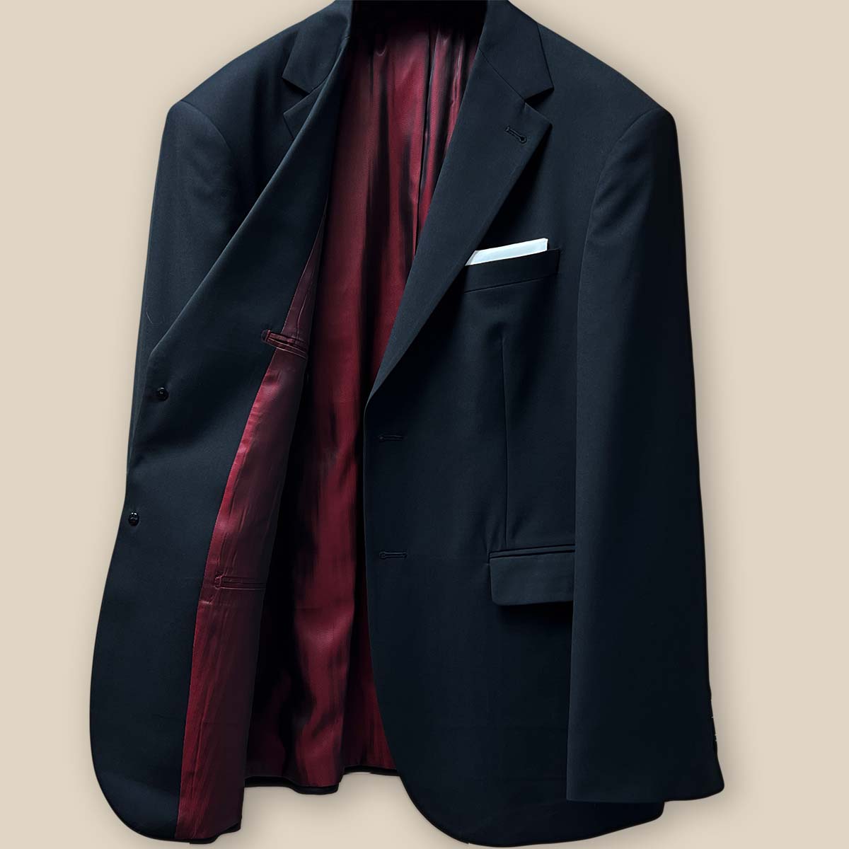 Inside view of the right side of the jacket emphasizing the quality of the maroon silk bemberg lining.