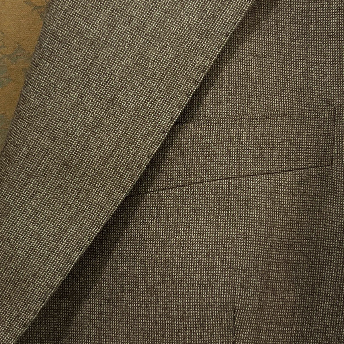 View of the built-in pocket square on the Westwood Hart brown nailhead men's suit jacket, adding a touch of elegance to the design.