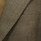 View of the built-in pocket square on the Westwood Hart brown nailhead men's suit jacket, adding a touch of elegance to the design.