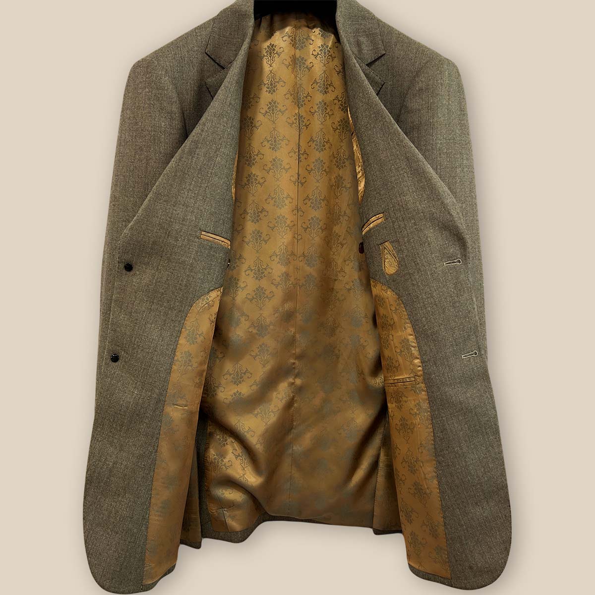 Detailed look at the gold patterned lining inside the Westwood Hart brown nailhead men's suit jacket, highlighting its luxurious finish.