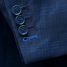 Close-up of the functional sleeve buttonholes on the dark blue windowpane men's sport coat with navy horn marble buttons.