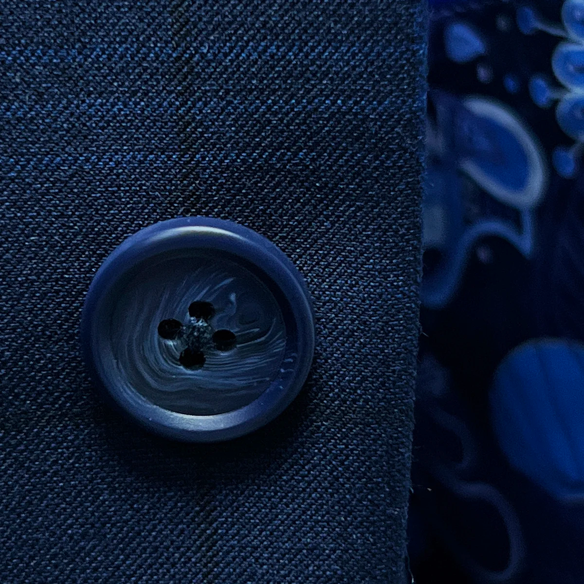 Close-up of the navy horn marble buttons on the dark blue windowpane men's sport coat.