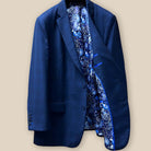 Interior view of the left side of the dark blue windowpane men's sport coat showcasing the blue and white aviary motif flash lining and royal blue piping.