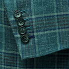 Functional sleeve buttonholes on the Westwood Hart hunter green with navy and chocolate brown plaid mens sport coat, with navy blue contrast accents on the last buttonhole.