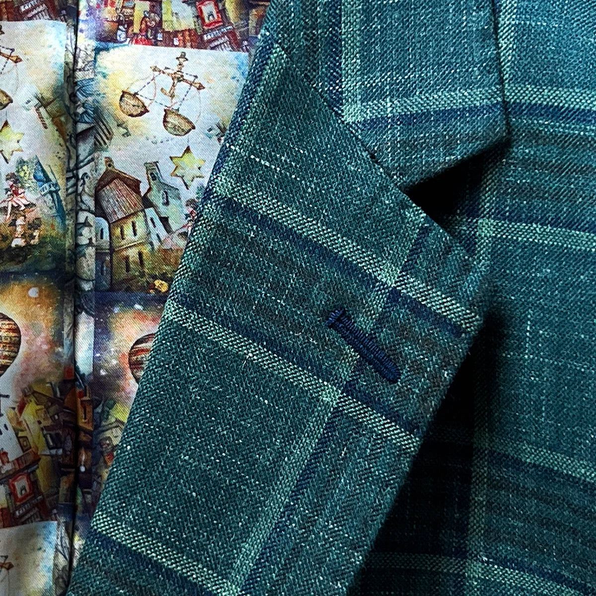 Detailed view of the notch lapel on the Westwood Hart hunter green with navy and chocolate brown plaid mens sport coat, featuring precise craftsmanship.