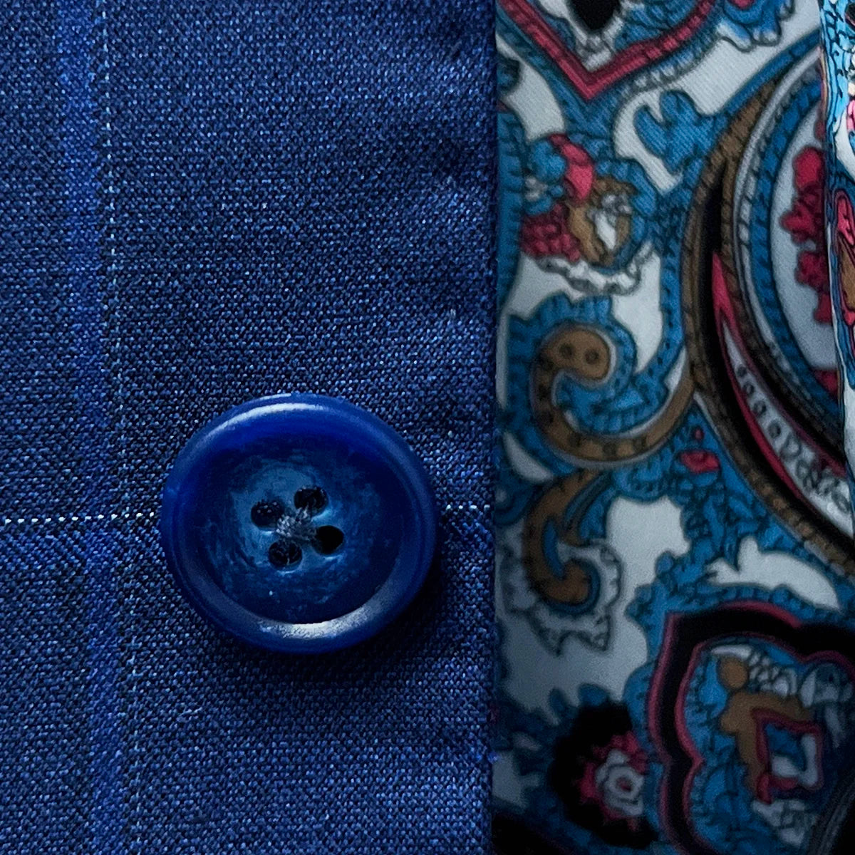 Close-up of the blue marble horn buttons on the royal blue suit with a navy and white windowpane pattern.