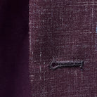 Close-up of the buttonhole stitching on a cranberry men's suit by Westwood Hart, showcasing precise tailoring.