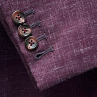 Functional sleeve buttonholes on a cranberry men's suit by Westwood Hart, emphasizing practical design and quality.