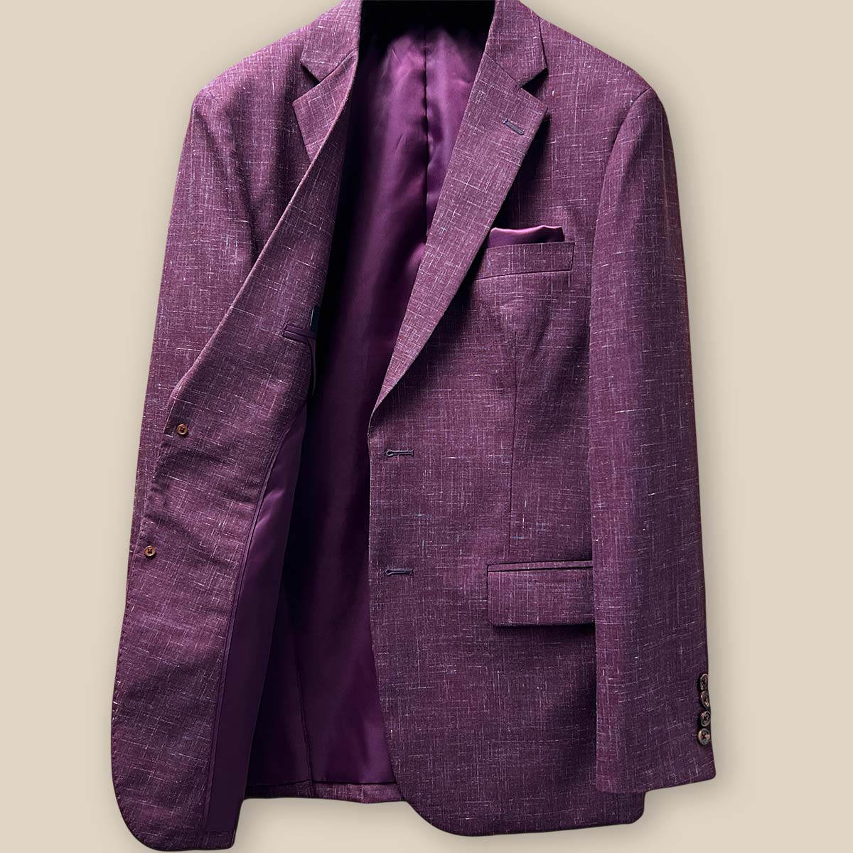 Interior view of the right side of a cranberry men's suit jacket by Westwood Hart, showing detailed stitching and pocket placement.