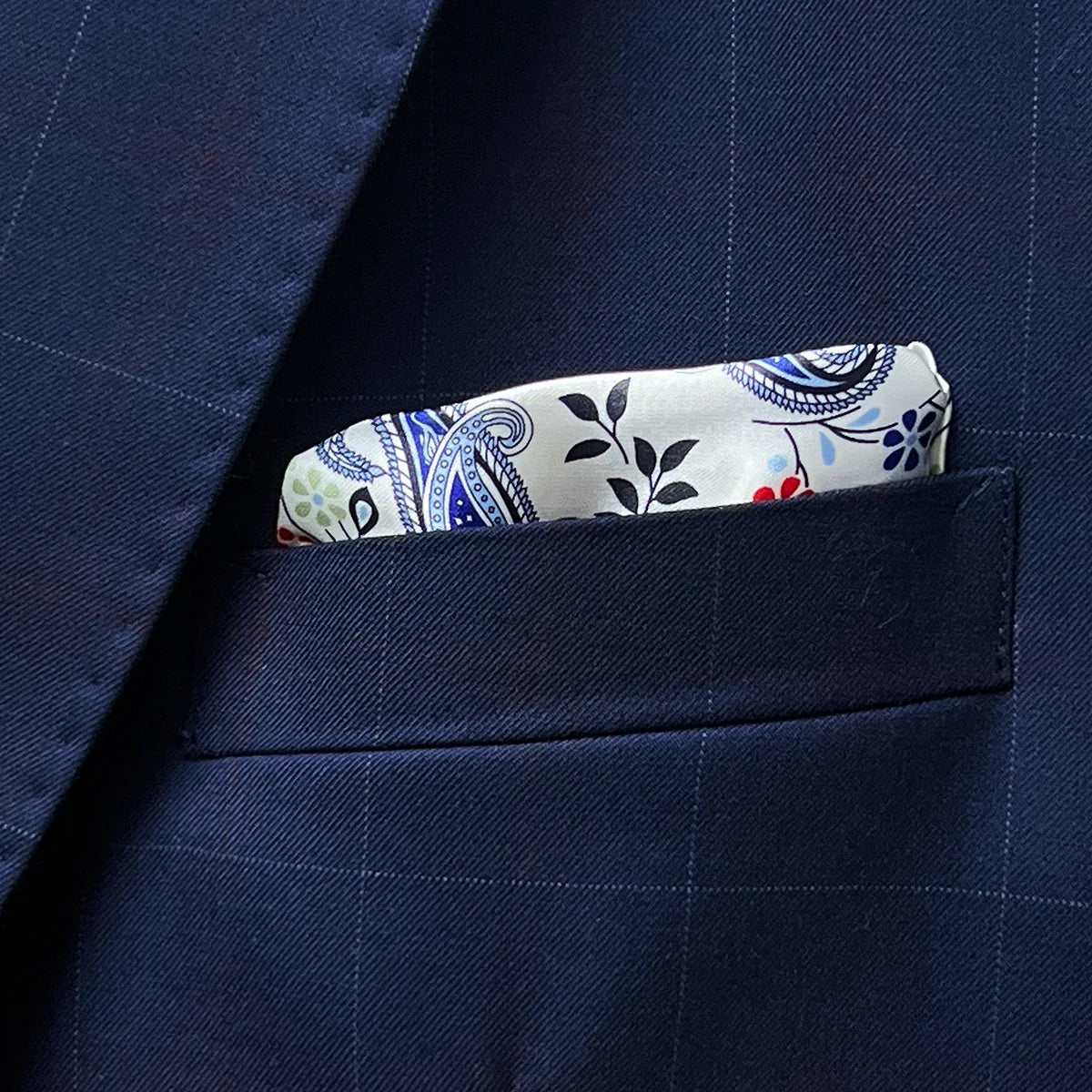 Close-up of built-in pocket square showing the white accent fabric that coordinates with the buttonhole detailing