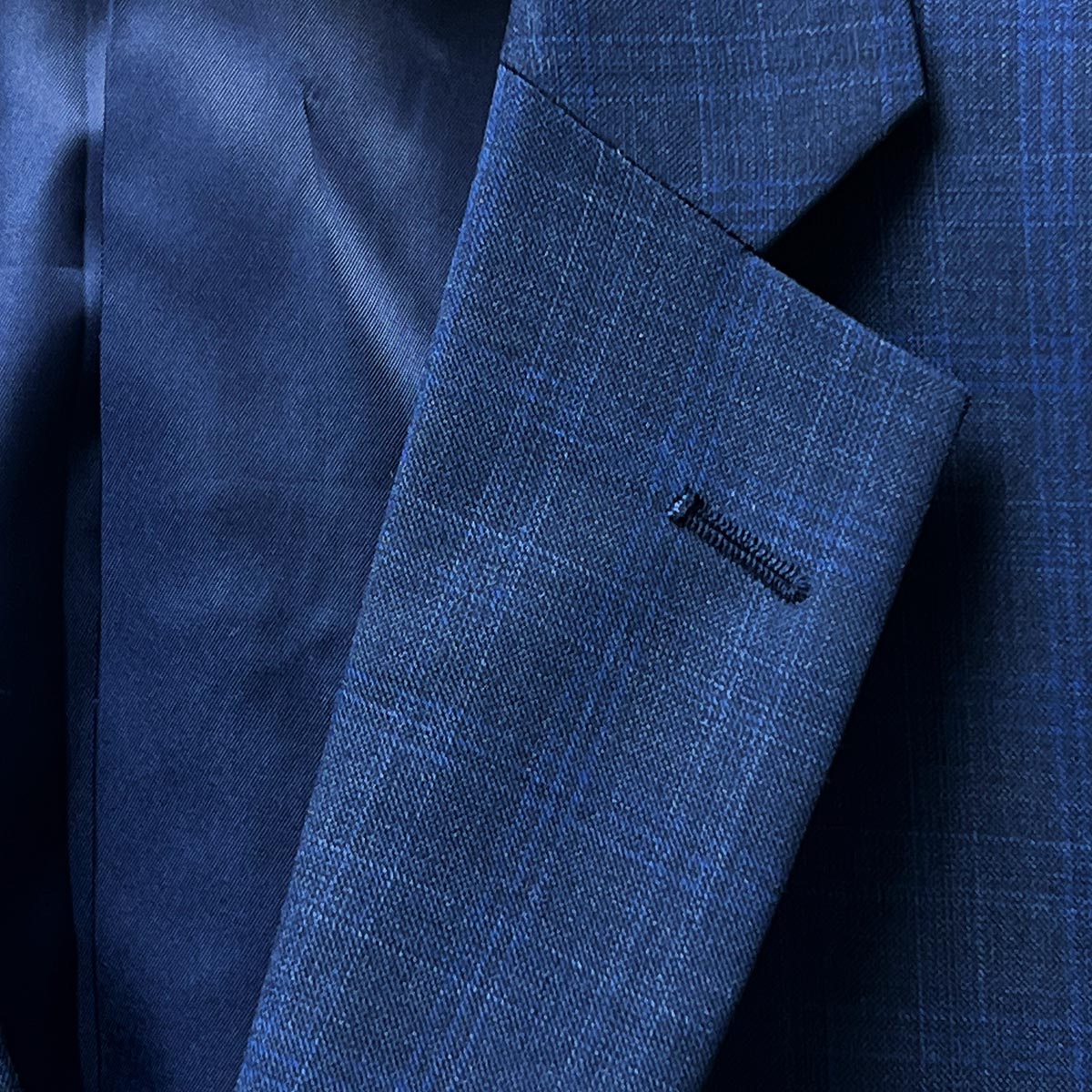 Jacket lapel on navy suit.