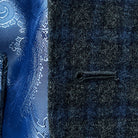 Close-up of a buttonhole on a grey blue grid check flannel sportcoat.