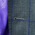 Close-up view of a buttonhole on the grey purple windowpane sportcoat.