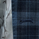 Close-up of the buttonhole on a Prussian Blue sportcoat with black grid checks.