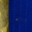 Close-up view of the buttonhole on a royal blue pinstripe suit.