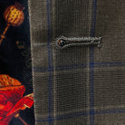 Close-up view of the buttonhole stitching on a chocolate brown sportcoat.