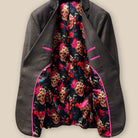 Detailed view of the "Born to Ride" theme lining with skulls and roses on a black background inside a chocolate brown sportcoat.