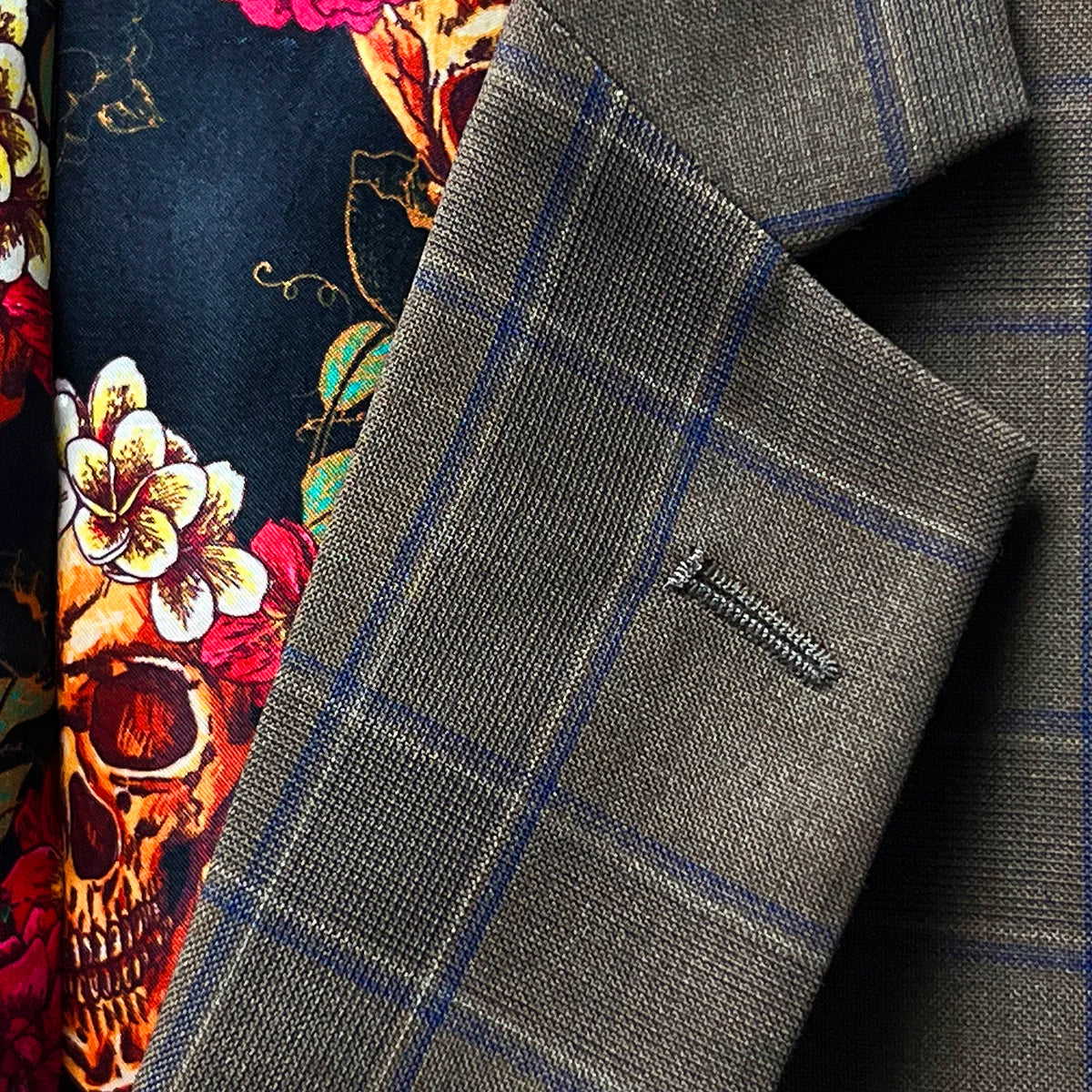 Detailed view of the notch lapel on a chocolate brown sportcoat.